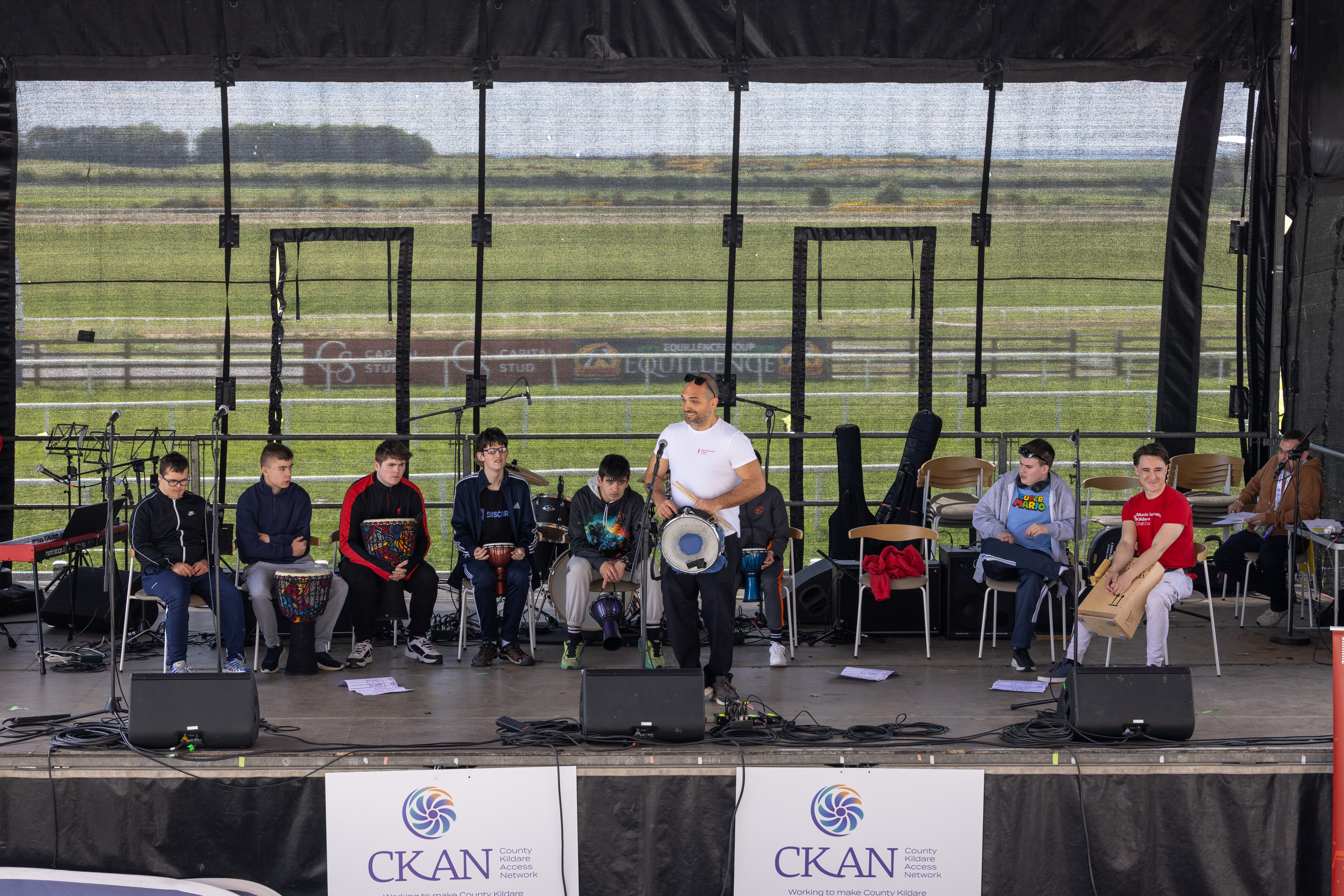People playing drums on stage. 